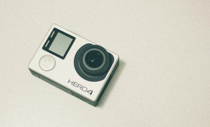 Top view of a GoPro Hero 4 action camera with a white background, emphasizing its design.